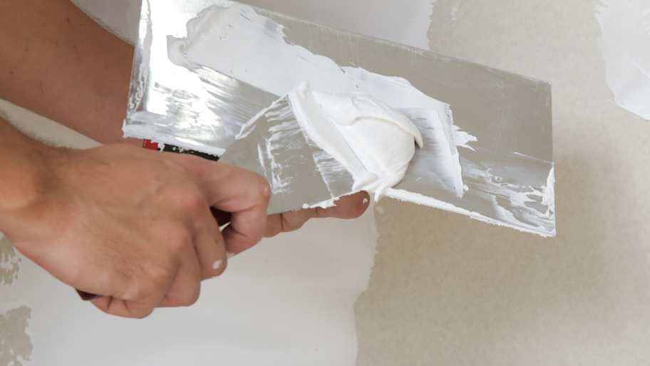 A person plastering a wall