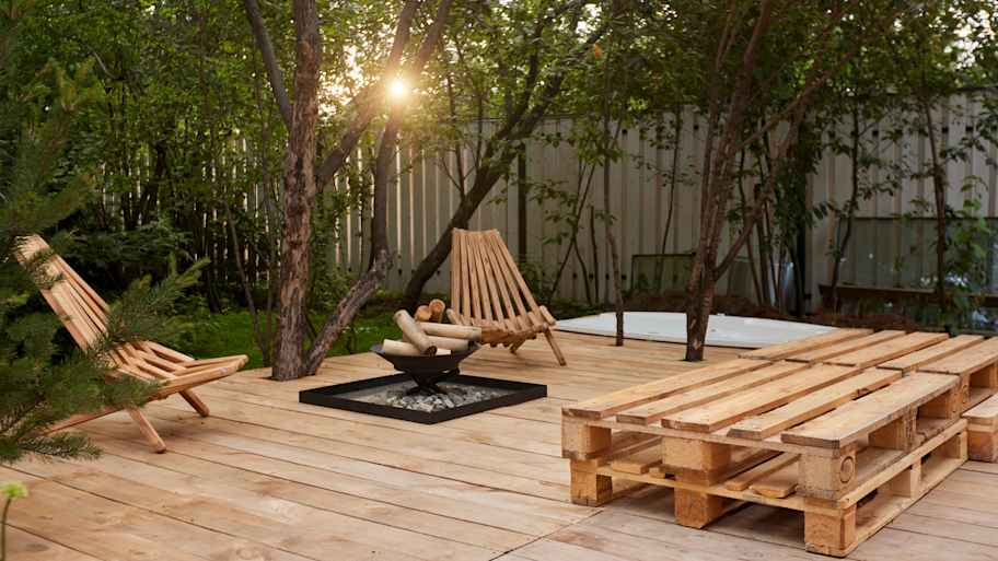 Fire place on the wooden terrace in garden  