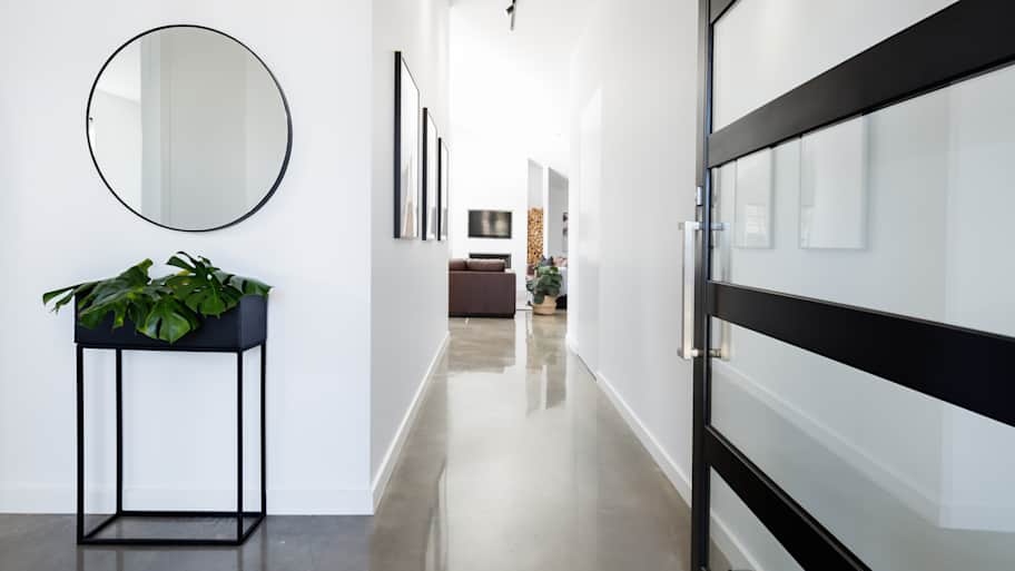 Contemporary home entryway with polished concrete floor