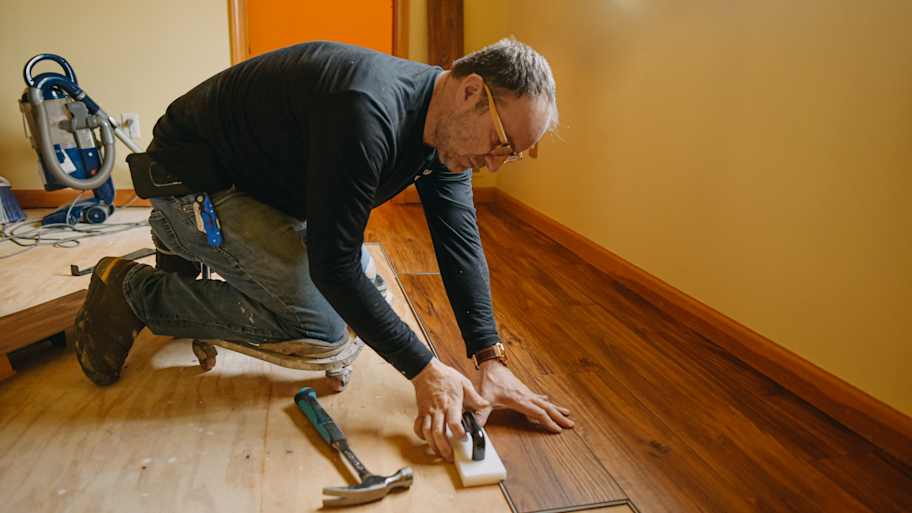 Man installing vinyl floor
