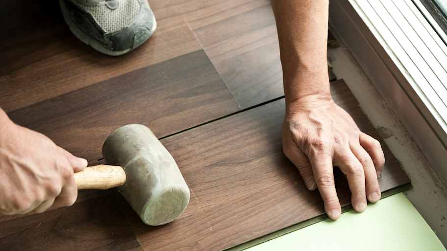 Man holding installing vinyl  floor