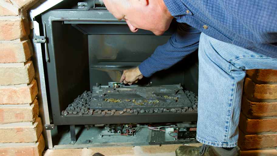 Worker checking out gas fireplace  