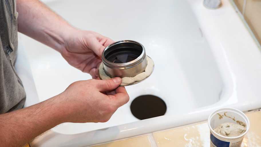 Man installing garbage disposal