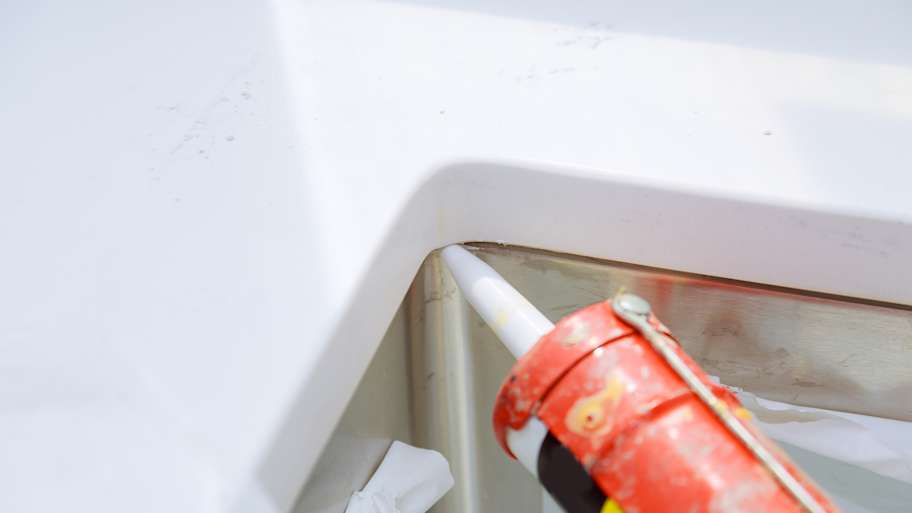 Worker installing granite sink