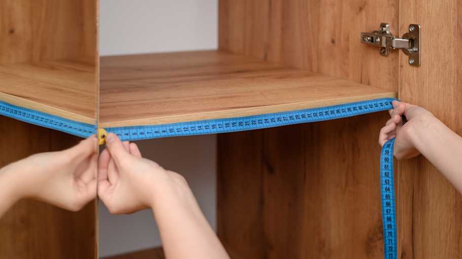  A person measuring a closet