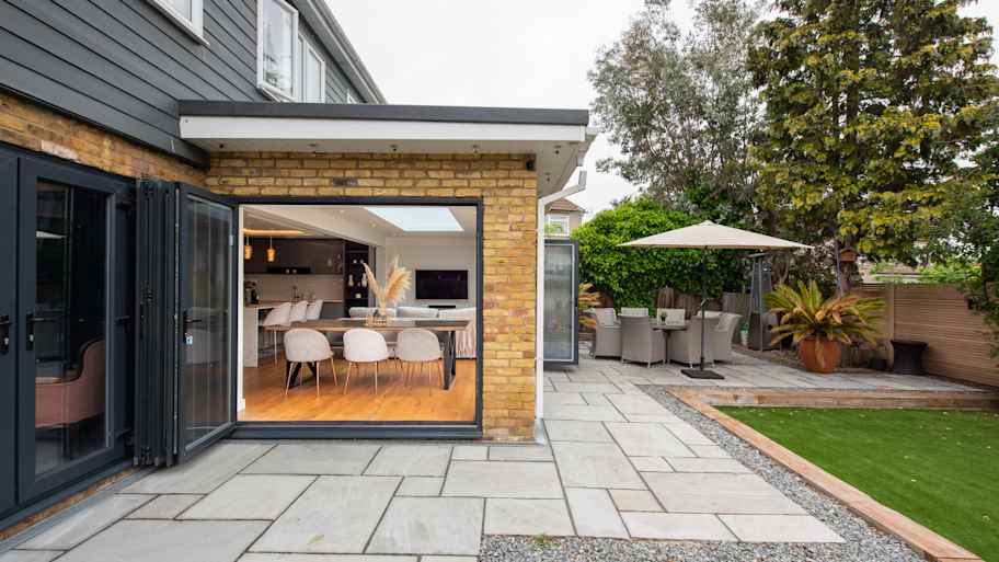 A backyard of a house with pavers
