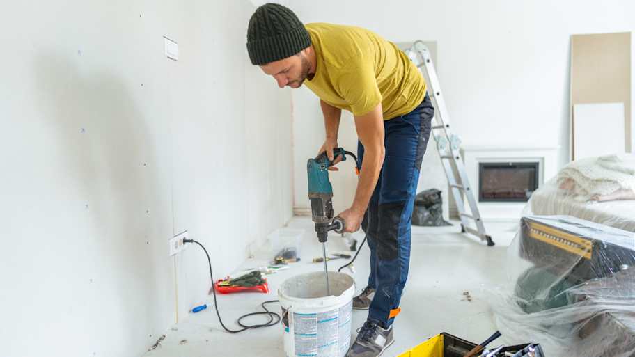 A professional mixing drywall mud