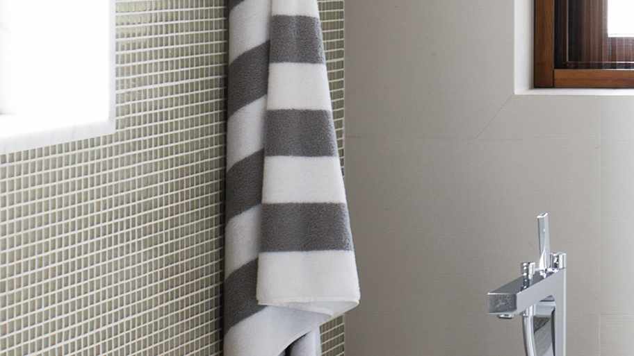 A bright bathroom with a white bathtub