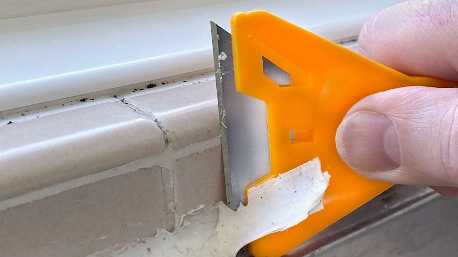 Scraping off old caulk from the shower