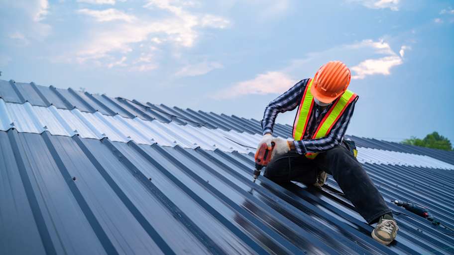 man installing metal roof