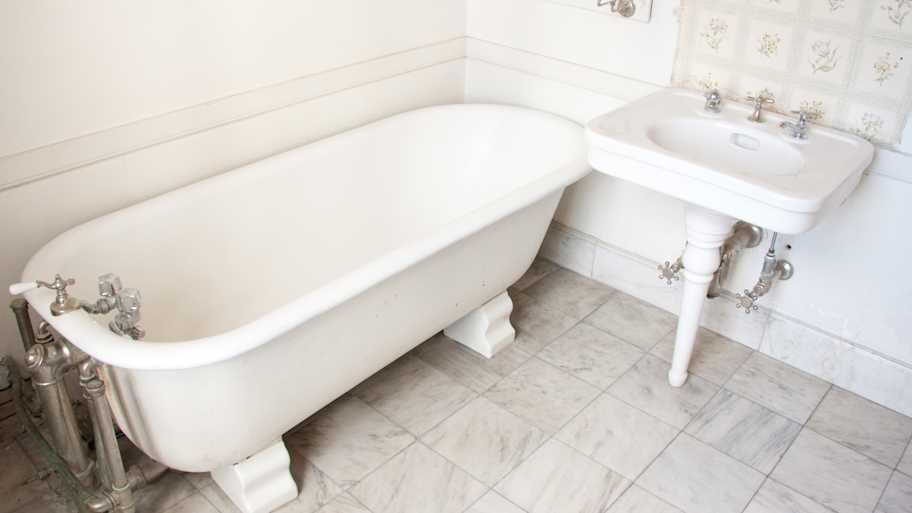 Bathroom tub with marble tile floor 