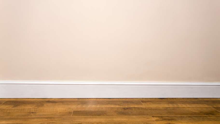 plain wall with a simple white baseboard