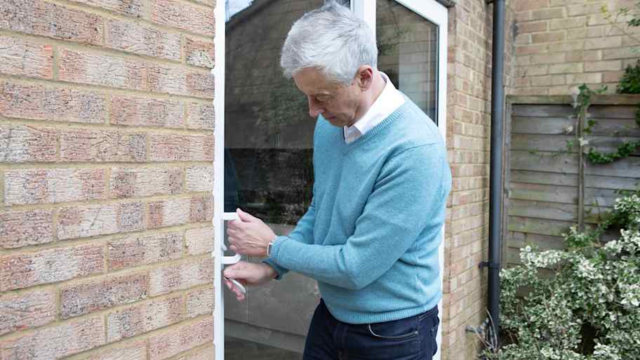 man unlocking a patio door