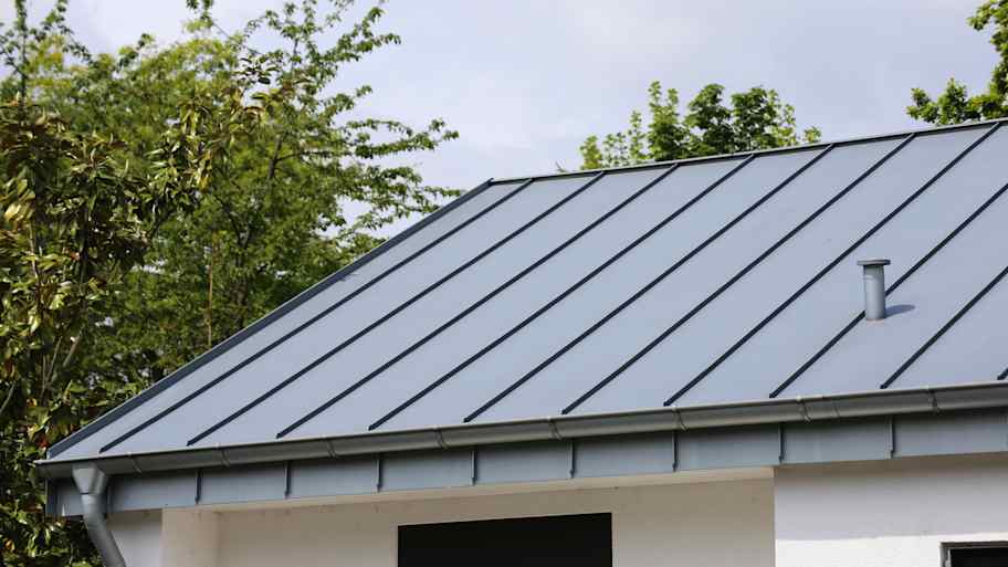 House with a gray standing seam metal roof   