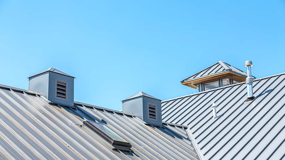 Standing seam metal roof and skylight window installed on a house