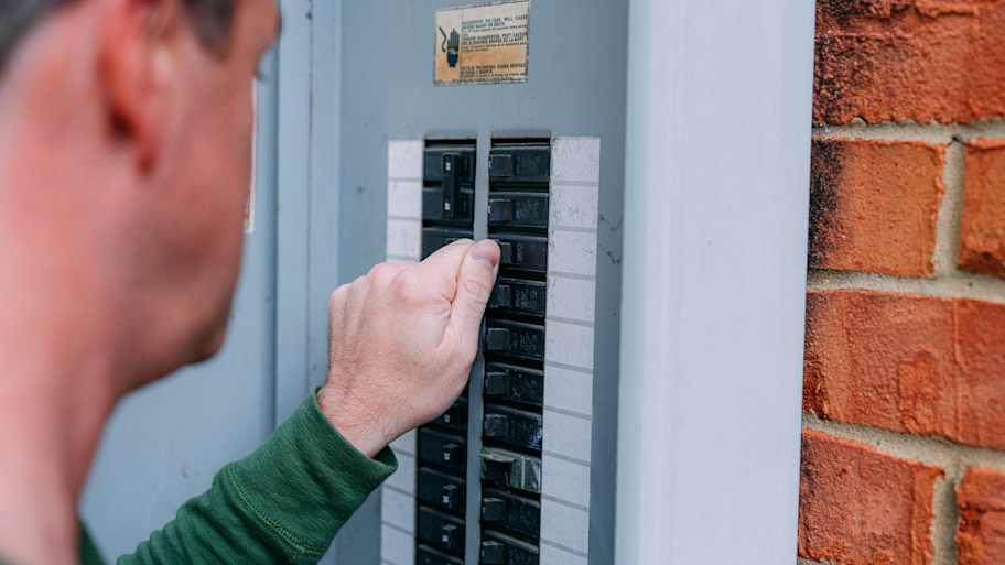Man checking a circuit breaker 