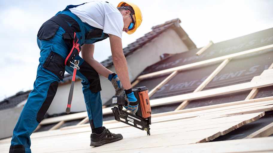 man repairing roof