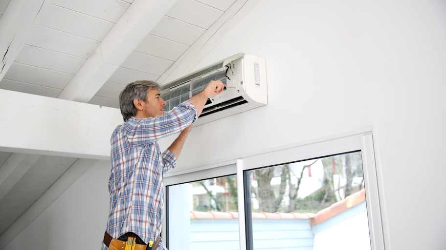 repairman fixing ac unit