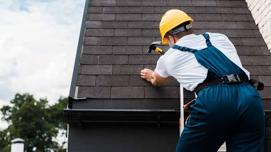 worker repairing roof