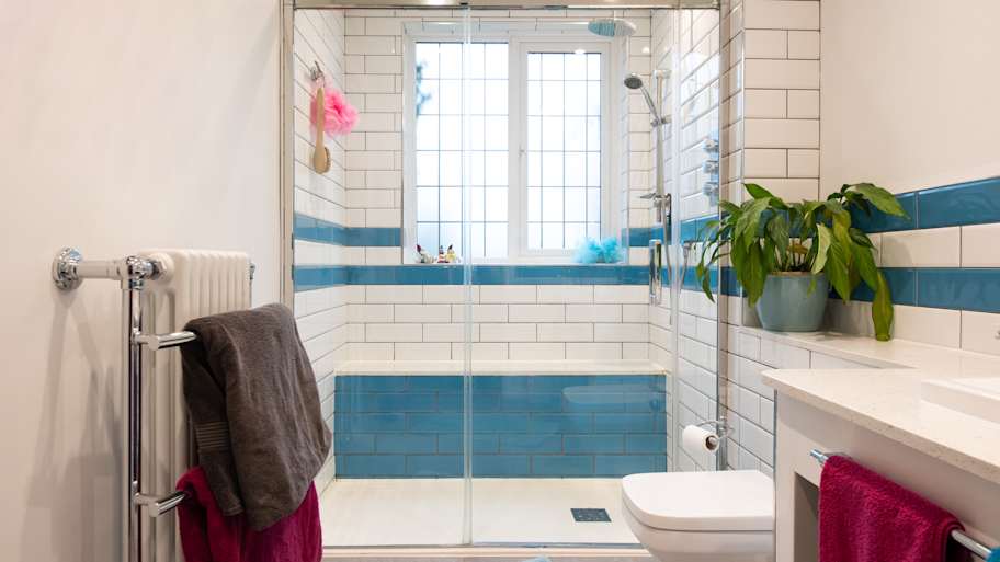  A general interior view of a white and blue tiled bathroom 