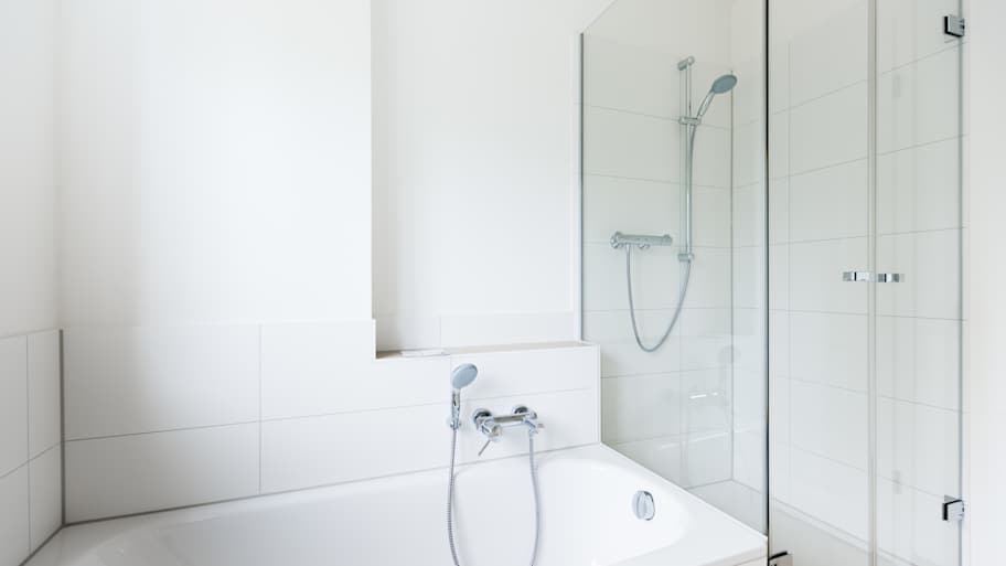Modern white bathroom with shower and bathtub 