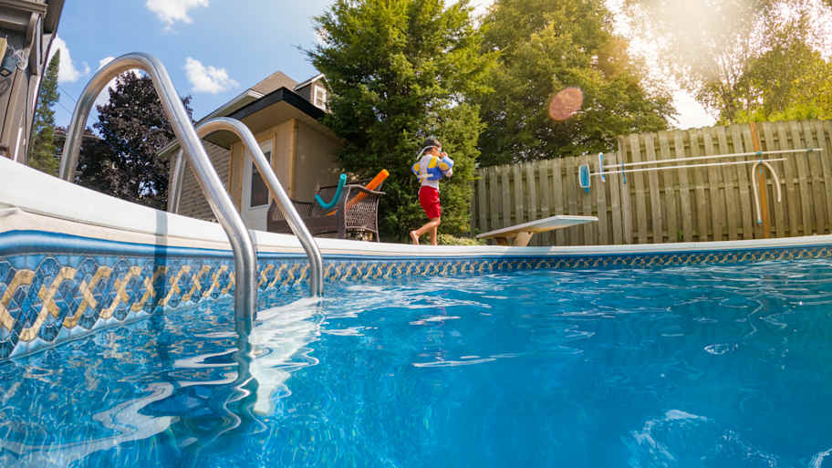 boy walking along pool
