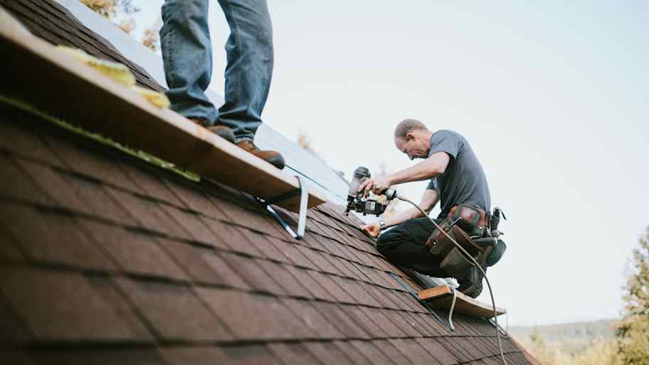 men installing new roof  