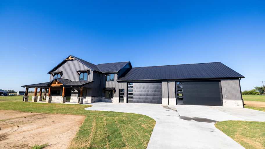 large home with black metal roof