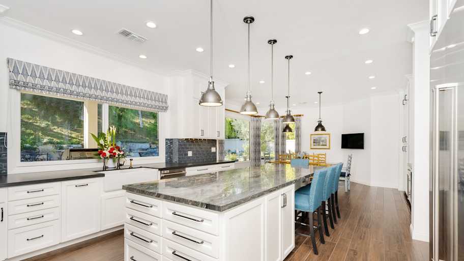 A spacious kitchen with granite countertop