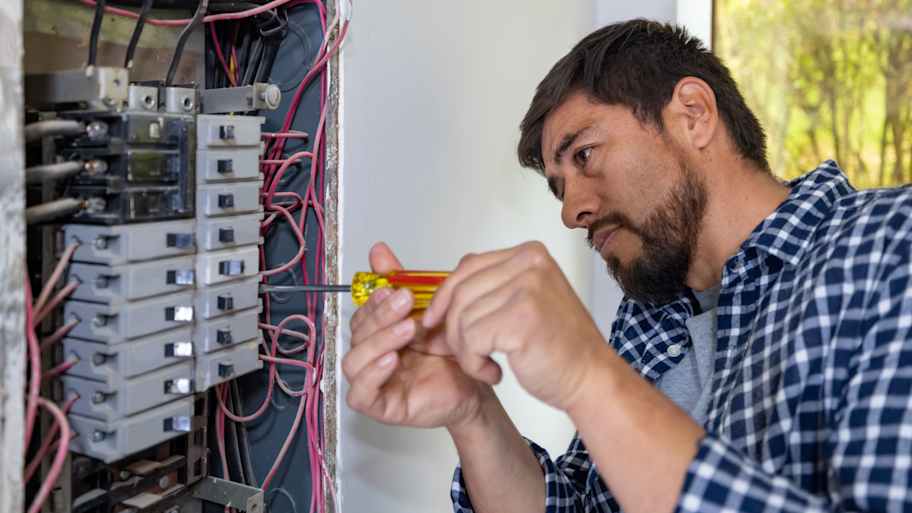 electrician fixing fuse box