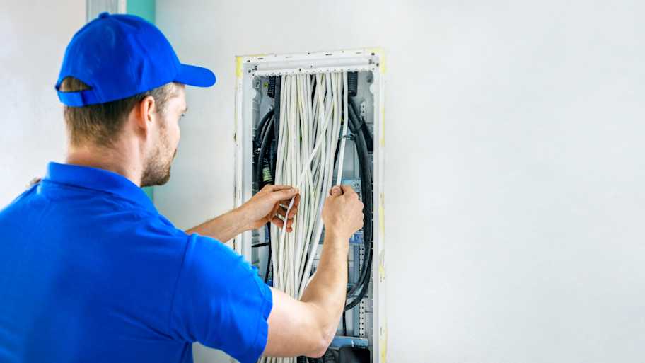 Electrician wiring a new electrical box in a house  