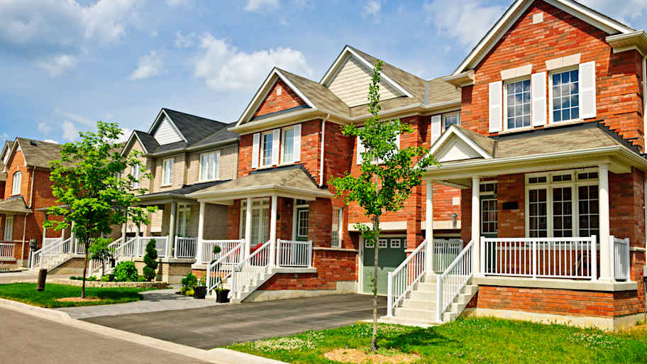 Street with a row of red brick houses  