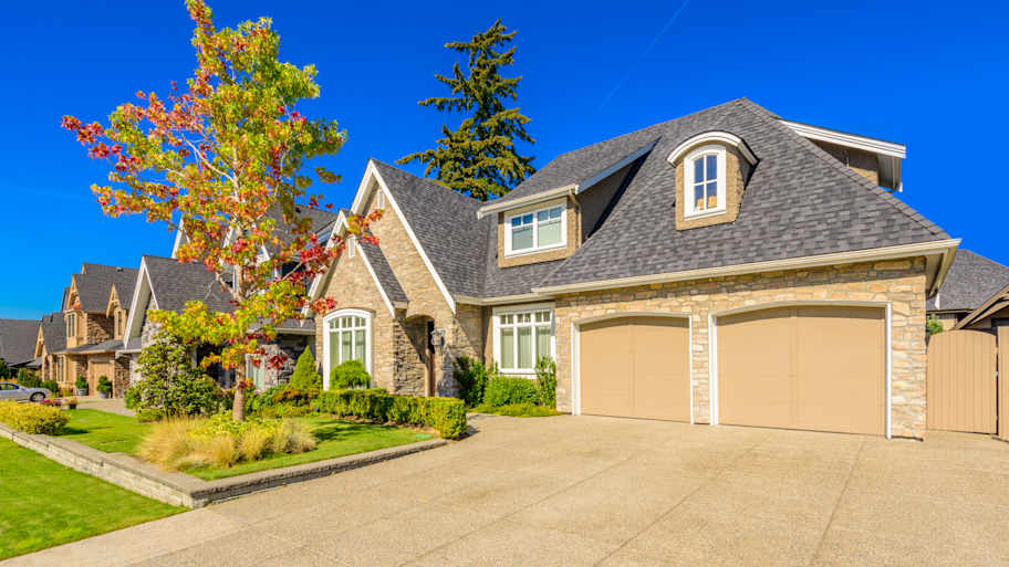 Houses with stone siding and asphalt shingle roof  