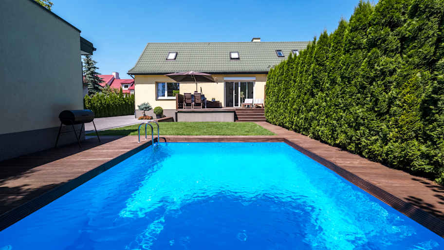 A pool in the backyard of a house