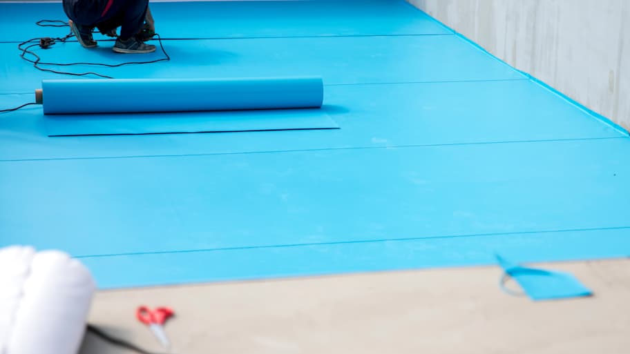 A professional installing a bottom pool liner