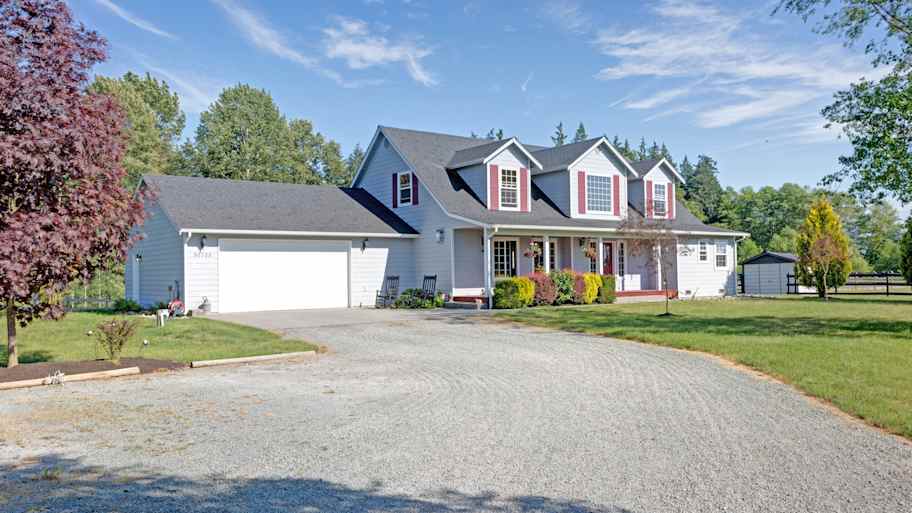 The exterior of a house with red shutters