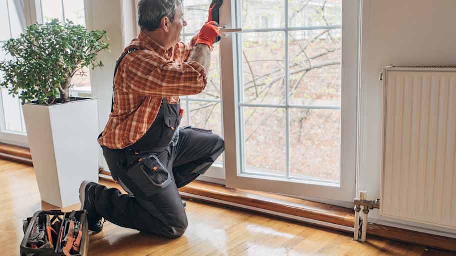 A professional installing a new window