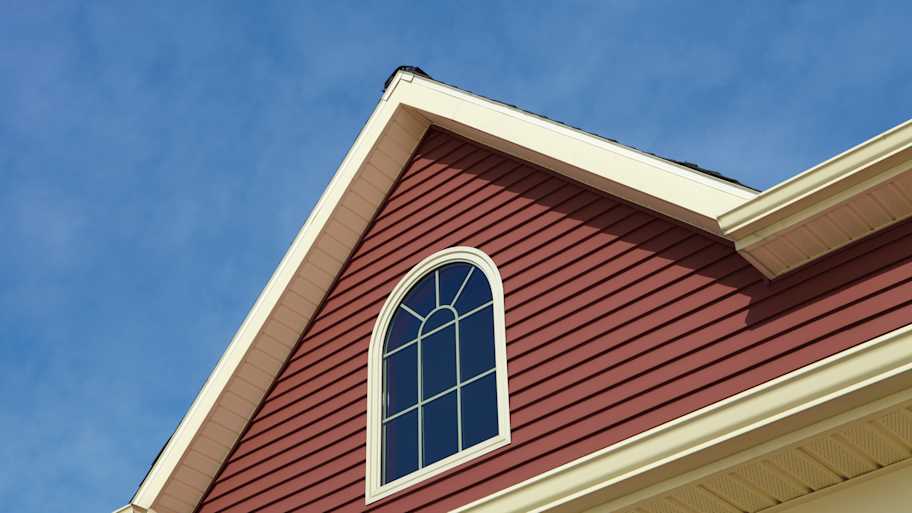 A house with siding against the blue sky
