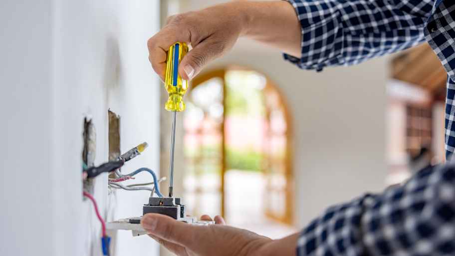 Electrician installing a power outlet