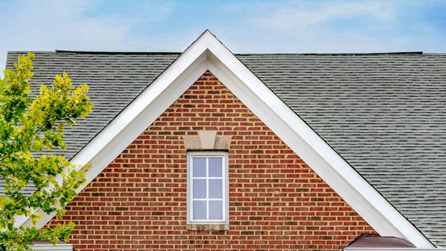 Gable roof on front exterior of brick townhouse 