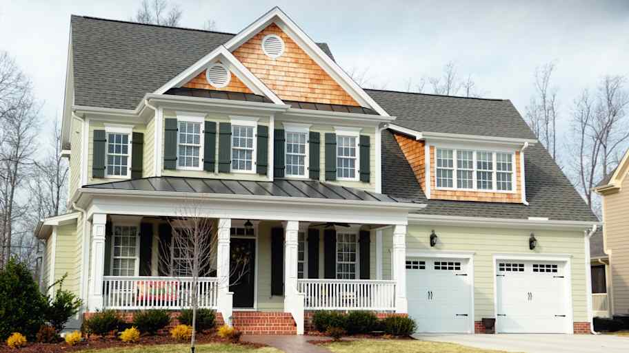 Two-story house with asphalt shingle roof and a front porch