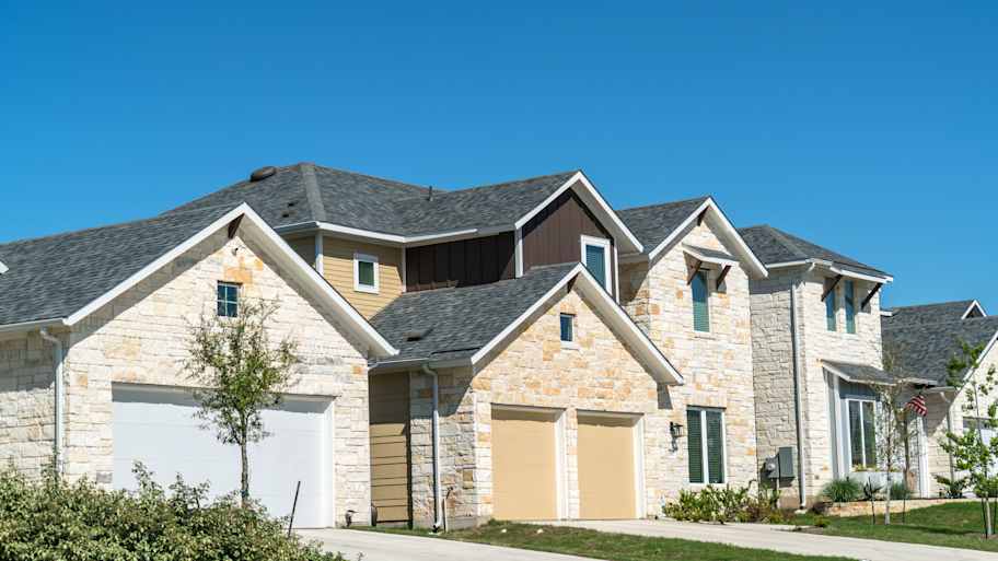 New houses with asphalt shingle roofs in Austin