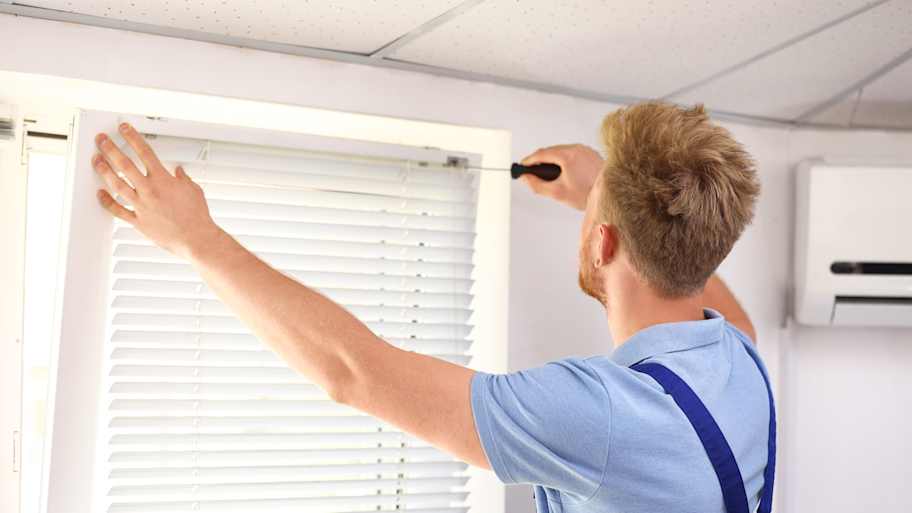 man installing blinds
