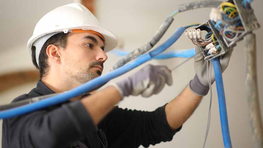 man rewiring house