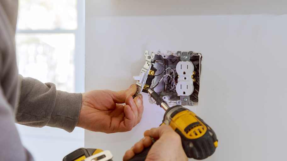 man rewiring outlet