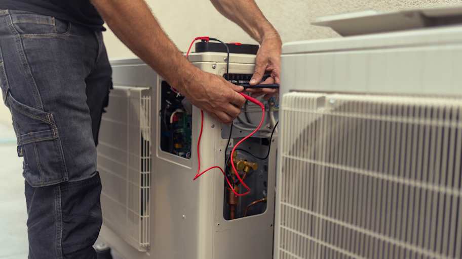 Electrician installing a heat pump