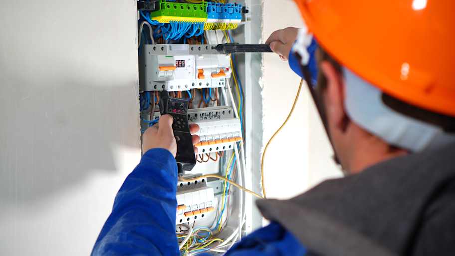 electrician testing switchboard  