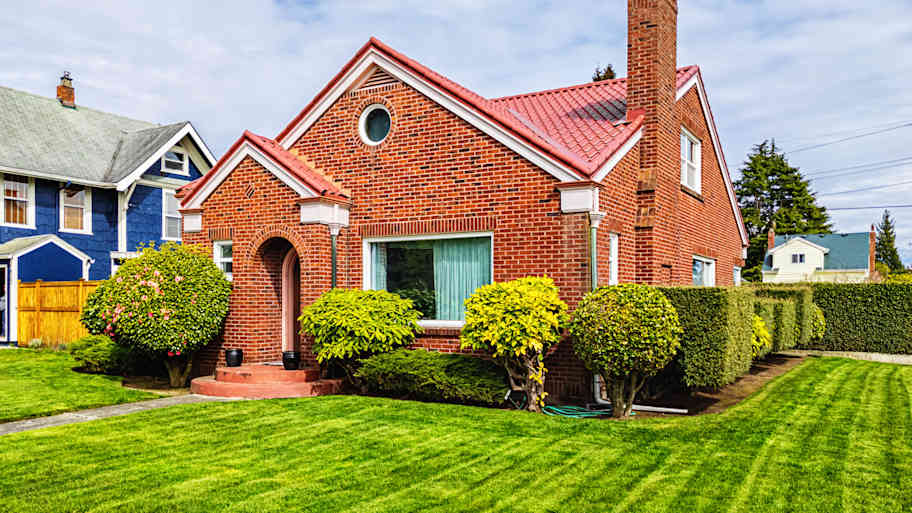 Small Red Brick House with Green Grass