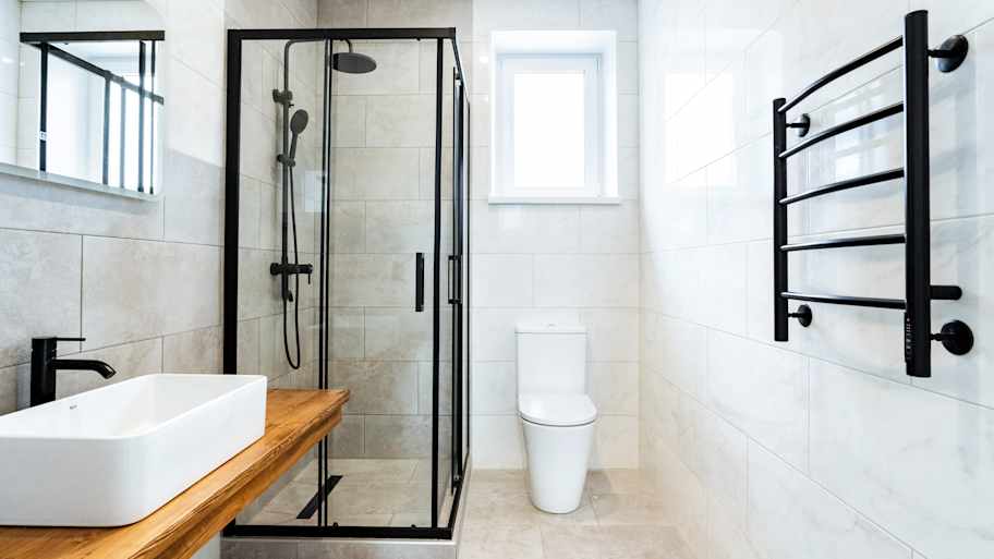 Black hardware installed in a bathroom with a small window