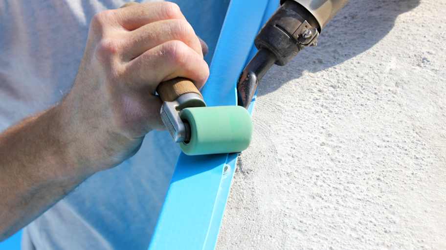 Close-up of a professional installing a new pool liner